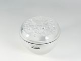 a silver box with a floral design on the lid