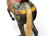 an old fashioned wooden horse with a saddle on it ' s back