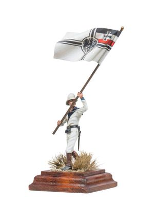 statue of a man holding a flag on a wooden base