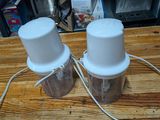 two salt and pepper shakers sitting on a wooden table