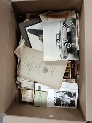 a box full of books and papers on the floor