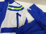 blue and white tracksuit with a green stripe on the side