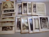 a lot of old black and white photos on a table