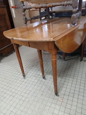 a wooden table with a wooden top on a tile floor