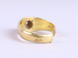 an image of a gold ring with a brown stone