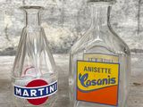 two empty bottles sitting next to each other on a table