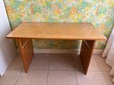 a wooden table that is sitting in front of a wall