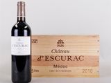 a bottle of red wine next to a wooden box