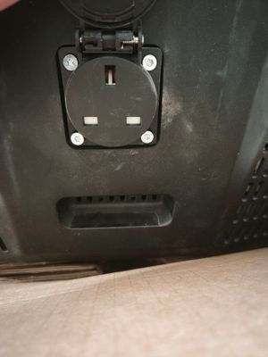 a close up of a person ' s hand holding an electrical outlet