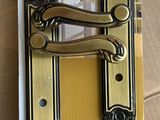 a close up of a gold door handle on a cardboard box