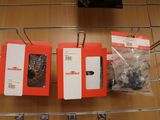three boxes of cell phones hanging on a wire rack
