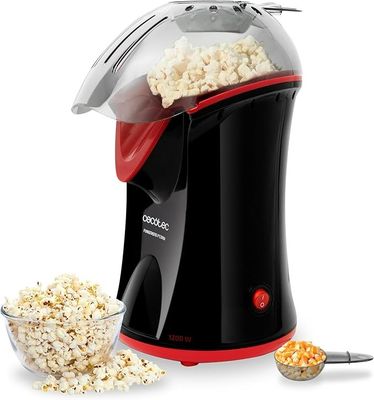 une image représentant une machine à pop-corn avec un bol de pop-corn à côté