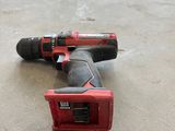 an electric drill is laying on the floor next to a pile of wood