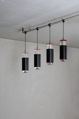 five lights hanging from the ceiling in a room