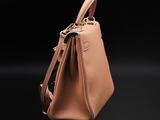 a small tan purse with a zipper on the front