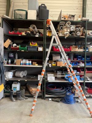 a ladder that is leaning against a wall in a garage