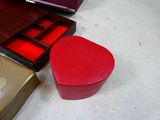 a red box sitting on the floor next to other boxes