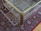 a glass coffee table on a rug in a living room