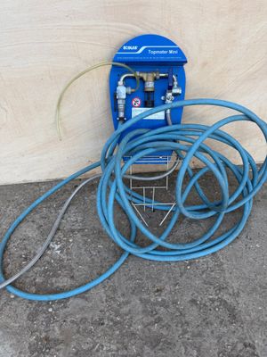 a hose attached to a blue hose on the ground
