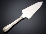 a close up of a knife on a table with a black background