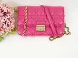 pink quilted purse with chain and flowers on white background