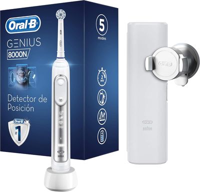 une photo d'une brosse à dents électrique blanche posée à côté d'un tube de dentifrice