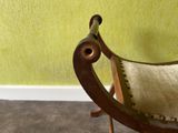 a chair that has a pillow on it in a room