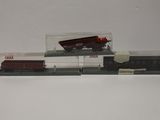 a toy train set with a red and white train on the tracks