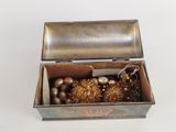a metal box with a bunch of ornaments inside of it
