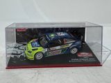 a toy car in a display case on a white surface