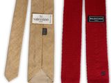 two ties with a label on them sitting next to each other