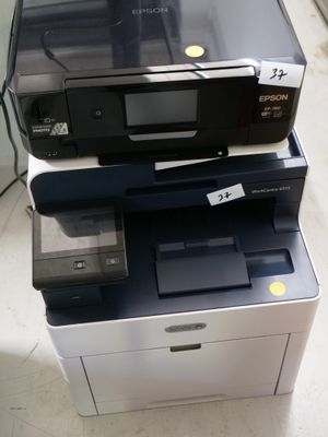 two printers sitting on top of each other on the floor