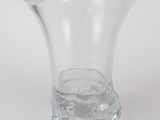 a clear glass vase sitting on a white surface