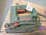 a green and red electric hand held sander on a table