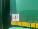 a close up of a green truck with a sticker on it ' s side