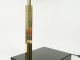 a black and gold table lamp with a black shade on it