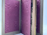 an open book with a purple cover on a white surface