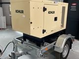 a trailer with a generator attached to it in a garage