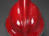 a red fireman ' s helmet on a black background