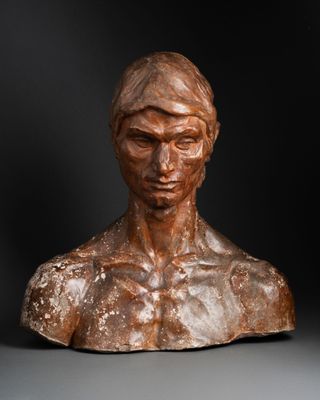 a bronze busturine of a man with no shirt on