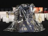 a bottle of perfume sitting on a table next to boxes