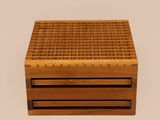 a close up of a wooden box on a white surface