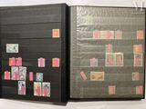 two black folders with stamps on them on the wall