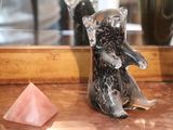 an elephant figurine sitting on a counter next to a crystal pyramid
