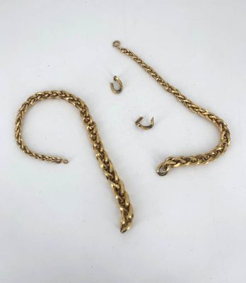 a close up of a gold chain with a hook on it