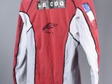 a close up of a red and white jacket hanging on a hanger