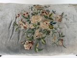 a small cushion with a bunch of flowers on it