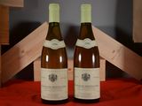 two bottles of wine sitting on a red table cloth