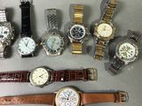 a lot of watches that are sitting on a table