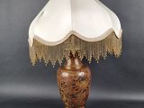 a lamp that is sitting on a table next to a lamp